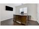 Office space featuring a large wooden desk, dark wood floors and a wall mounted TV at 6205 Windy Oaks Ct, Las Vegas, NV 89139