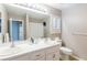 Bathroom featuring double sinks, a large mirror, toilet, shower and neutral decor creating a clean and functional space at 6251 Tuckaway Cove Ave, Las Vegas, NV 89139