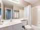 Clean bathroom with a single sink vanity, bathtub/shower combo, and neutral decor at 6251 Tuckaway Cove Ave, Las Vegas, NV 89139