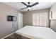Comfortable bedroom featuring a window with shutters, a ceiling fan, and neutral decor, offering a relaxing retreat at 6251 Tuckaway Cove Ave, Las Vegas, NV 89139