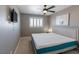 Comfortable bedroom featuring a window with shutters, a ceiling fan, and neutral decor, offering a relaxing retreat at 6251 Tuckaway Cove Ave, Las Vegas, NV 89139