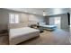 Spacious bedroom featuring two beds, lounge chair, ceiling fan, and neutral decor for a relaxing retreat at 6251 Tuckaway Cove Ave, Las Vegas, NV 89139