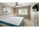 Comfortable bedroom featuring a window with shutters, a ceiling fan, and neutral decor, offering a relaxing retreat at 6251 Tuckaway Cove Ave, Las Vegas, NV 89139