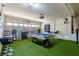A fun game room featuring a pool table, sports decor, and turf flooring perfect for entertainment at 6251 Tuckaway Cove Ave, Las Vegas, NV 89139