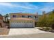 Two-story home featuring a three-car garage, desert landscaping and tile roof at 6251 Tuckaway Cove Ave, Las Vegas, NV 89139