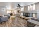 Spacious living room featuring fireplace, ceiling fan, and wood-look tile flooring at 6251 Tuckaway Cove Ave, Las Vegas, NV 89139