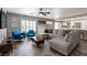 Inviting living room with modern furniture, lots of light, and open to the kitchen at 6251 Tuckaway Cove Ave, Las Vegas, NV 89139