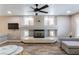 Living room featuring fireplace, ceiling fan, and tile floors at 6251 Tuckaway Cove Ave, Las Vegas, NV 89139
