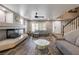 Living room featuring fireplace, ceiling fan, and tile floors at 6251 Tuckaway Cove Ave, Las Vegas, NV 89139