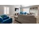 Comfortable living room with a large sectional sofa, stylish decor, and bright windows at 6251 Tuckaway Cove Ave, Las Vegas, NV 89139