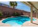 Beautiful backyard pool with attached spa, surrounded by lush greenery and privacy walls at 6251 Tuckaway Cove Ave, Las Vegas, NV 89139