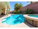 Inviting pool and spa area with mature landscaping and lounge seating at 6251 Tuckaway Cove Ave, Las Vegas, NV 89139
