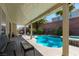 Inviting backyard pool with covered patio, perfect for outdoor relaxation and entertaining at 6251 Tuckaway Cove Ave, Las Vegas, NV 89139