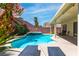 Sparkling backyard pool and spa surrounded by lush landscaping, ideal for leisure and enjoyment at 6251 Tuckaway Cove Ave, Las Vegas, NV 89139
