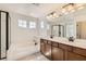 Bathroom featuring a bathtub, dual sinks, and modern dark hardware at 632 Cadence Vista Dr, Henderson, NV 89011