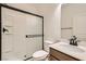 Bathroom featuring a shower with glass door, toilet, sink, and modern black hardware at 632 Cadence Vista Dr, Henderson, NV 89011