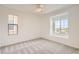 Neutral bedroom with a ceiling fan and natural light from the two windows at 632 Cadence Vista Dr, Henderson, NV 89011