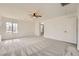 Neutral bedroom featuring a ceiling fan, carpet, a door, and large windows at 632 Cadence Vista Dr, Henderson, NV 89011