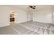 Bright bedroom leading to the bathroom featuring modern carpet and neutral walls at 632 Cadence Vista Dr, Henderson, NV 89011