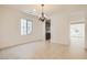 Bright dining room featuring neutral tile flooring, chandelier, and a view into the kitchen at 632 Cadence Vista Dr, Henderson, NV 89011