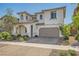 Charming two-story home with stucco siding, arched entryway, and manicured landscaping at 632 Cadence Vista Dr, Henderson, NV 89011