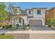 Charming two-story home with stucco siding, arched entryway, and manicured landscaping at 632 Cadence Vista Dr, Henderson, NV 89011