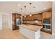 Modern kitchen with granite countertops, stainless steel appliances, and a center island at 632 Cadence Vista Dr, Henderson, NV 89011