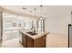 Modern kitchen island with granite countertop, stainless steel appliances and views of living room at 632 Cadence Vista Dr, Henderson, NV 89011