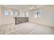 Spacious loft area with neutral carpet, windows, ceiling fan and railing overlooking downstairs at 632 Cadence Vista Dr, Henderson, NV 89011