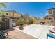 Spacious backyard with concrete patio, BBQ grill, shed, and desert landscaping, perfect for outdoor living at 6409 Dundock Ave, Las Vegas, NV 89122
