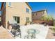 The backyard features a concrete patio with a BBQ grill, table with glass top, and low-maintenance landscaping at 6409 Dundock Ave, Las Vegas, NV 89122