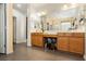 Bathroom with double sinks, wood cabinets, and a large mirror at 6409 Dundock Ave, Las Vegas, NV 89122