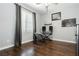 Well-lit bedroom with wood floors, gray curtains, and a keyboard at 6409 Dundock Ave, Las Vegas, NV 89122
