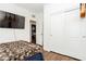 Bedroom with TV, wood floors, closet, and view to connecting bedroom at 6409 Dundock Ave, Las Vegas, NV 89122