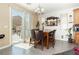 Dining area with sliding glass doors to the backyard and modern tile floors at 6409 Dundock Ave, Las Vegas, NV 89122