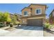 Well-maintained two-story home with a stone-accented facade, two-car garage, and desert-style landscaping at 6409 Dundock Ave, Las Vegas, NV 89122