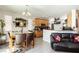 Well-lit kitchen area with wooden cabinetry, granite countertops, modern appliances, and a seamless flow to the living area at 6409 Dundock Ave, Las Vegas, NV 89122