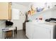 Functional laundry room equipped with washer, dryer, and storage cabinets at 6409 Dundock Ave, Las Vegas, NV 89122