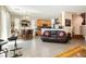 Bright living area showcasing tile floors, an open layout, and comfortable seating adjacent to the kitchen at 6409 Dundock Ave, Las Vegas, NV 89122