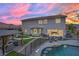 Backyard view with pool, gazebo, lush grass, outdoor seating, and serene ambiance at 7211 Heggie Ave, Las Vegas, NV 89131