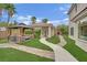 Lush backyard featuring a gazebo with outdoor seating and a landscaped walkway at 7211 Heggie Ave, Las Vegas, NV 89131