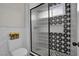 Contemporary bathroom showcasing decorative star tile, glass shower, and modern toilet at 7211 Heggie Ave, Las Vegas, NV 89131