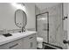 Modern bathroom with sleek vanity, black framed mirror and shower at 7211 Heggie Ave, Las Vegas, NV 89131
