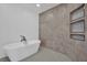 Luxurious bathroom with a sleek freestanding tub, designer tile, and open shelving at 7211 Heggie Ave, Las Vegas, NV 89131