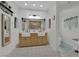 Modern bathroom with double sink vanity, decorative mirror, shiplap accent wall, and tiled floors at 7211 Heggie Ave, Las Vegas, NV 89131