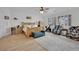 Spacious bedroom features a wooden bed, ceiling fan, sitting area, and a large window at 7211 Heggie Ave, Las Vegas, NV 89131