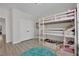 Well-lit ' bedroom features triple bunk beds, light wood floors and a white closet at 7211 Heggie Ave, Las Vegas, NV 89131