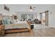 Bright bedroom with a wooden bed, a ceiling fan and sliding barn doors to the bathroom at 7211 Heggie Ave, Las Vegas, NV 89131