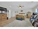 Large bedroom with light wood floors, a ceiling fan, a sitting area, and lots of space at 7211 Heggie Ave, Las Vegas, NV 89131