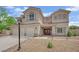 Beautiful two-story home with a three-car garage, inviting porch and desert landscaping at 7211 Heggie Ave, Las Vegas, NV 89131